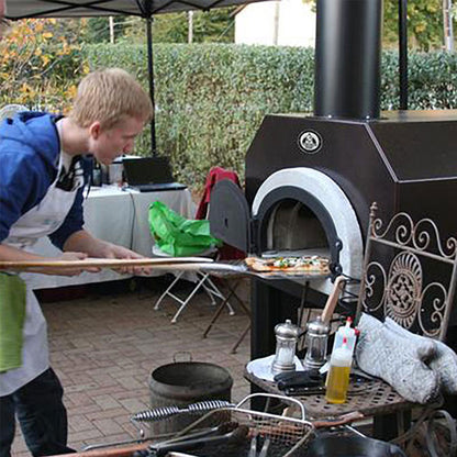 Chicago Brick Oven 500 Countertop Wood Fired Pizza Oven - Man baking Pizza